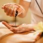 closeup massage therapist pouring hot chocolate her hands before spa treatment 2 85x85