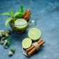 tea cup with mint cinnamon dried herbs lime grungy blue surface high angle view 85x85